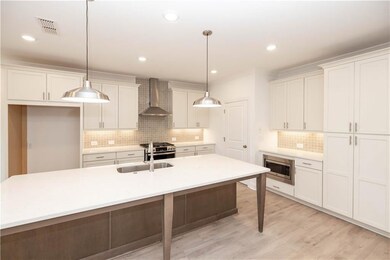 Stainless appliances include gas stove, venthood, dishwasher and built in microwave.
