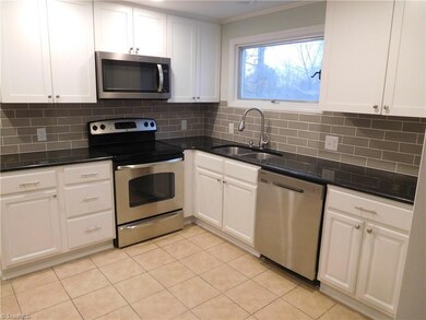 Bright Kitchen w/granite counters, tile backsplash, pantry & Stainless Steel Appliances.