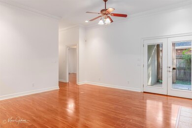 Empty room with french doors, light wood-type floo