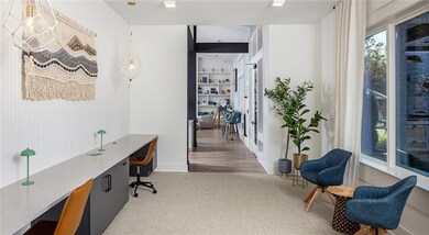 Office space featuring carpet floors, built in desk, and french doors