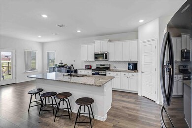 The large island will seat 4 easily.