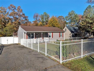 Paved driveway and fully fenced in yard with vinyl