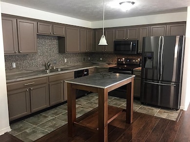 Streamlined kitchen featuring a versatile island a