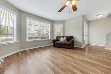 Living area with baseboards, ceiling fan, and ligh