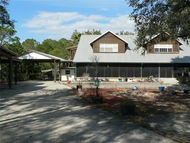 Oversized RV/Carport Leads to Out Buildings in Bac