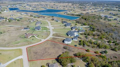 Aerial view of residential area featuring a nearby body of water and property parcel outlined
