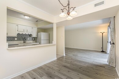 Kitchen featuring white cabinetry, white refrigera
