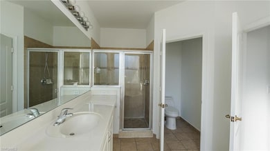 Full bath with tile patterned flooring, toilet, a 