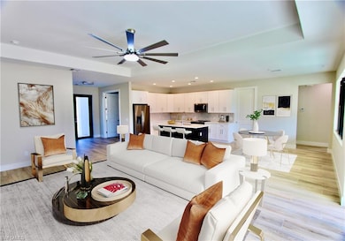 Kitchen with ceiling fan, tasteful backsplash, lig