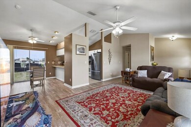 Living room featuring lofted ceiling, light wood-t
