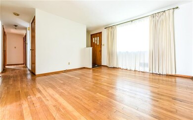 View of the large living room window and hall whic