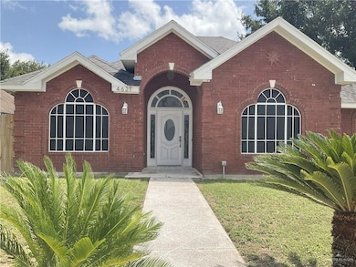View of front of property with brick siding and roof with shingles
