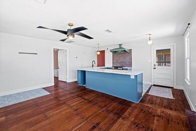 Kitchen with light countertops, wall chimney rang
