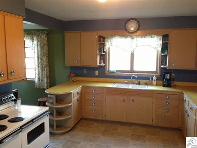 Spacious kitchen with newer vinyl flooring.