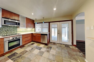 Kitchen with light wood-type flooring, appliances 