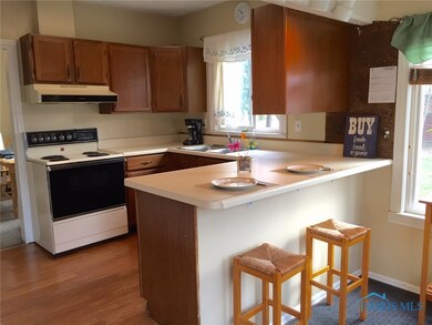Kitchen with snack bar and laminate flooring