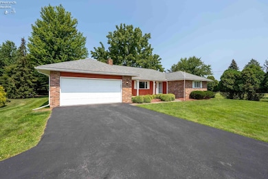 2 Car attached garage w/wide driveway and extra parking pad, inside the garage is a separate 19x10 workshop.