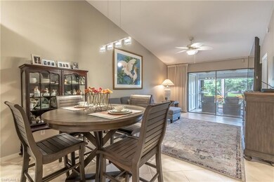Dining area featuring lofted ceiling, a ceiling fan, and light tile patterned flooring
