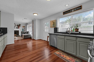 A well-lit kitchen featuring a large window above