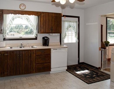 Kitchen. Lots of counters and cabinets. Door to th