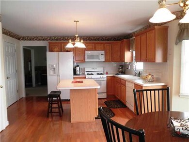 Kitchen Kitchen with hardwood floors, island and s