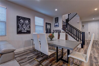 Dining space with stairs, wood finished floors, re