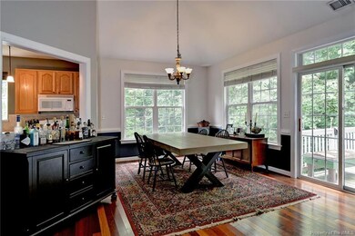 Lots of windows overlooking wooded yard.