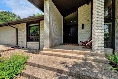 Doorway to property featuring brick siding