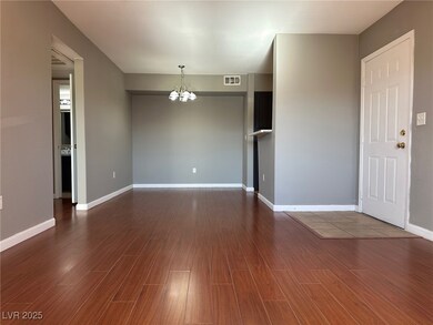 Unfurnished room with a chandelier and dark wood-s