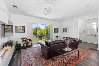 Living room with ceiling fan, wood finished floor