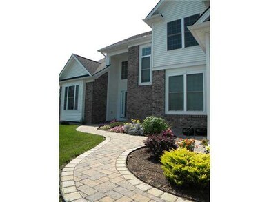 Exterior Front. Extensive landscaping with stone w