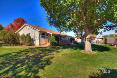 View of front facade with a front lawn and a deck