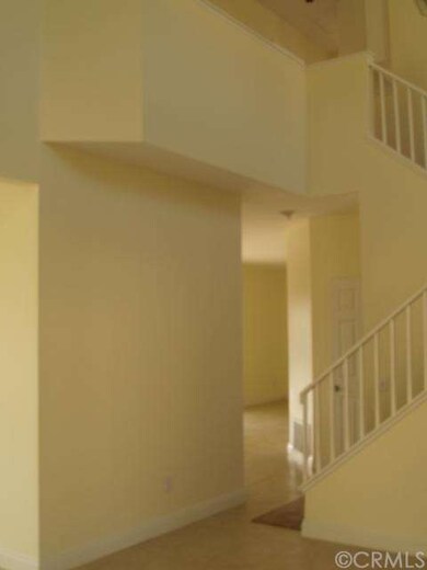 View from living room into family area. Fresh paint and new tile flooring