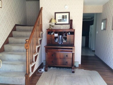 The open foyer extends a wide...