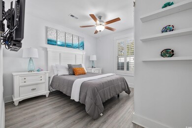 Bedroom with visible vents, baseboards, light wood