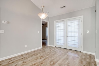 Interior space with vaulted ceiling and light hard