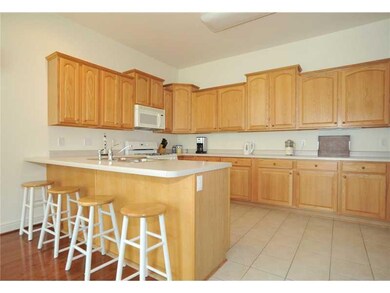 Kitchen. Gleaming wood and ceramic floors, generou