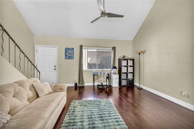 Living area featuring stairway, baseboards, and wo