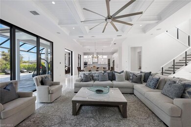 Living area featuring beamed ceiling, ceiling fan 