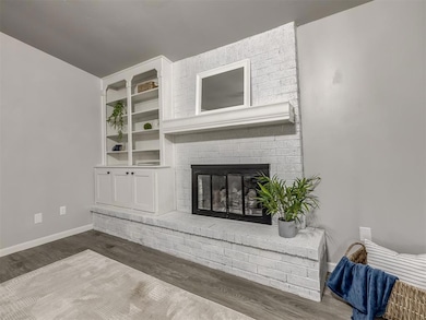 Living area featuring wood finished floors and a fireplace