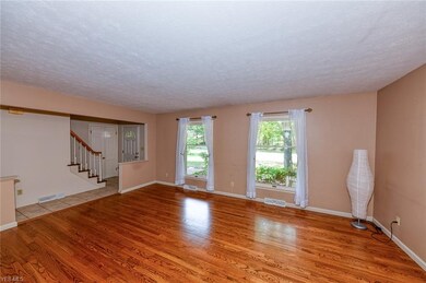 Living room with hardwood floors and large windows