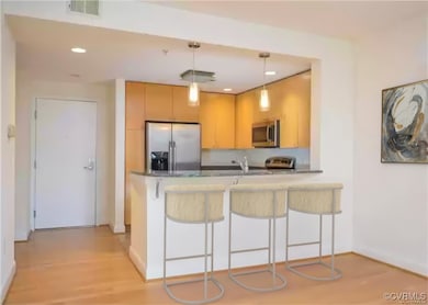 Kitchen with visible vents, appliances with stainl