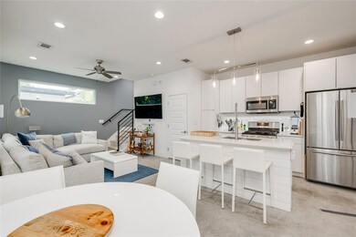 Living area featuring concrete floors, recessed l