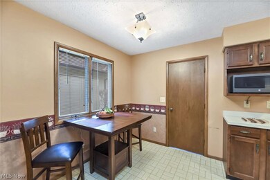 Dining space with a textured ceiling and light tile floors