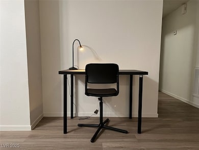 Office space featuring wood finished floors and ba