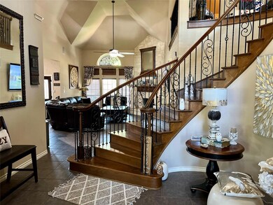 Stairway with baseboards, high vaulted ceiling, ti