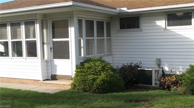 Storm door into 3 Season Room.  Concrete walk path leading up to it.