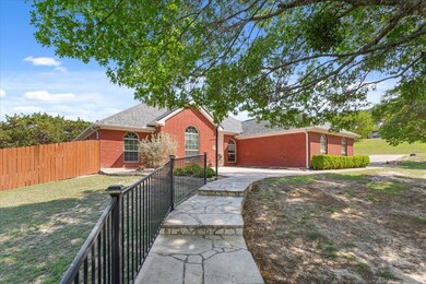 View of front of house featuring brick siding, a f