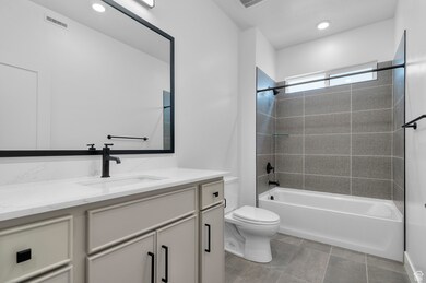 Full bathroom with shower / bath combination, vanity, and recessed lighting