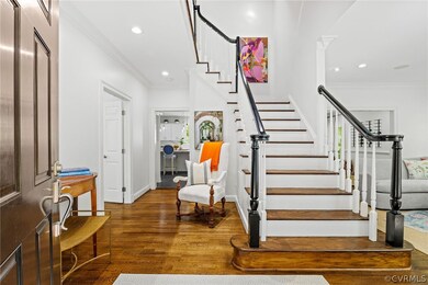 Front foyer with shining hardwoods and a gracious
